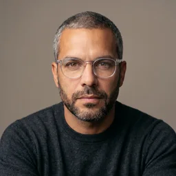 Portrait of the custom AI avatar Andre Laurent, built once in Playcut and reused across every surface