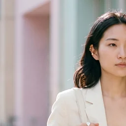 Editorial portrait of Mira Chen, the custom AI actor built once in Playcut and reused across every campaign